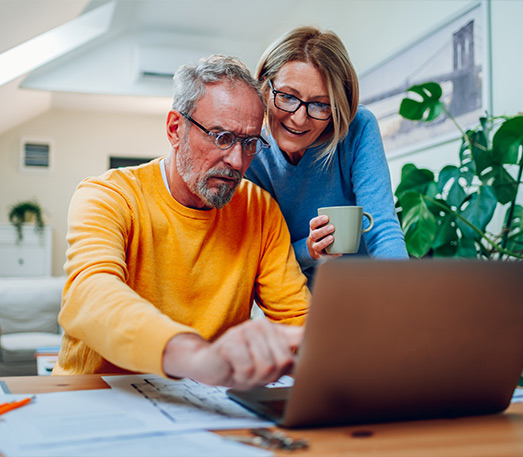 couple reviewing their finances on their laptop retirement income strategy