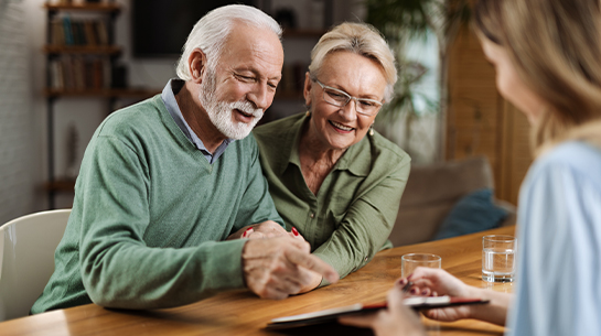 financial advisor meeting with senior clients to discuss annuity for retirement
