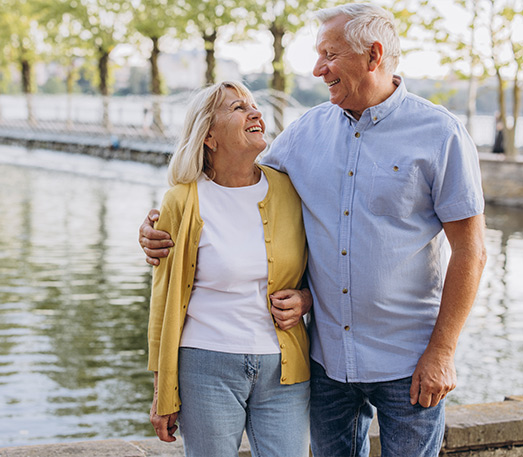 retired couple on a walking path by the water