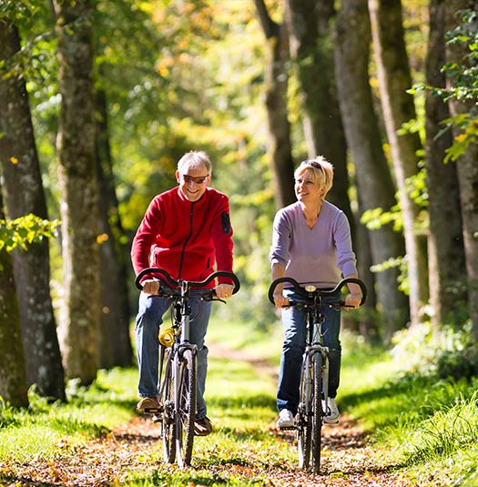 retirees biking through the woods