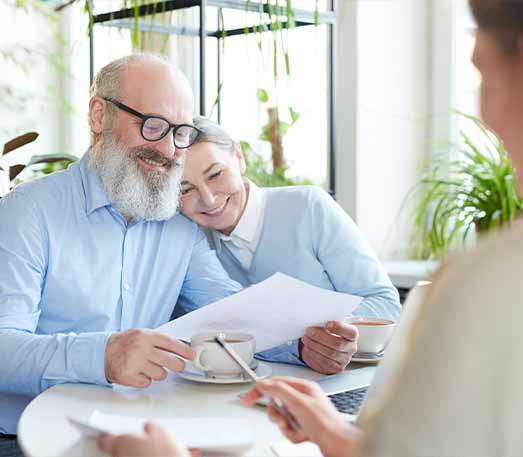 senior couple meeting with financial advisor to discuss life insurance for retirement